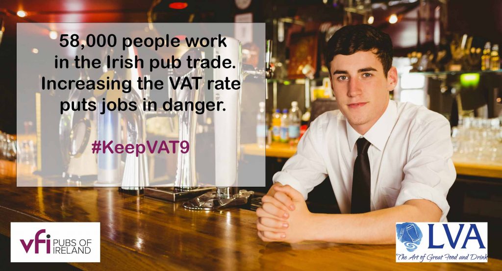 Portrait of confident male bartender sitting at bar counter